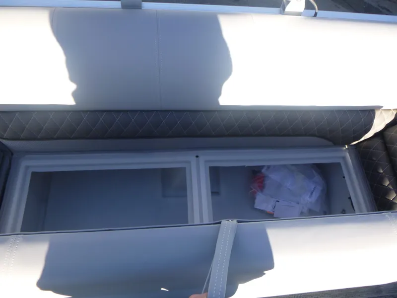 Slide: The Image of 2024 Ranger Reata 223C boat storage compartment with quilted upholstery. - 21