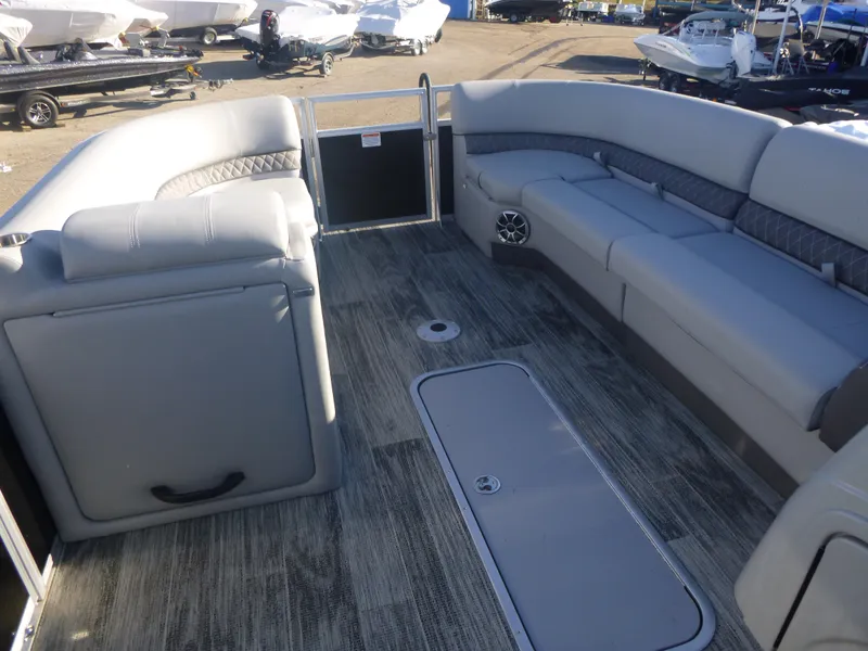 Slide: The Image of 2024 Ranger Reata 223C boat interior with gray seating and flooring. - 23