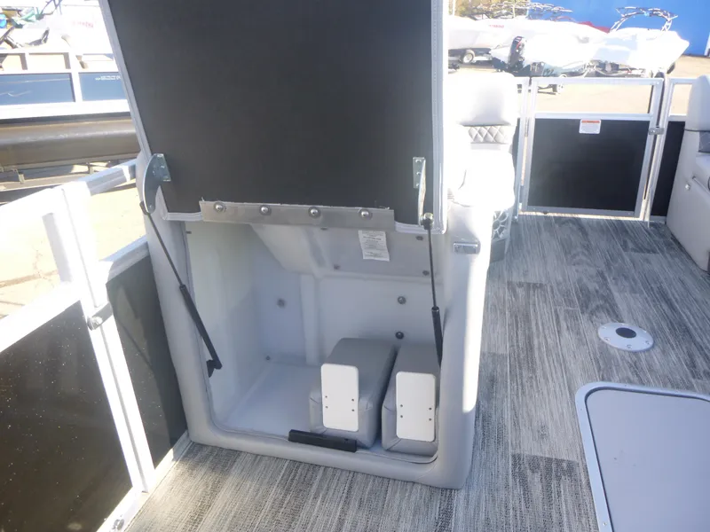 Slide: The Image of 2024 Ranger Reata 223C boat interior storage compartment with open hatch. - 24