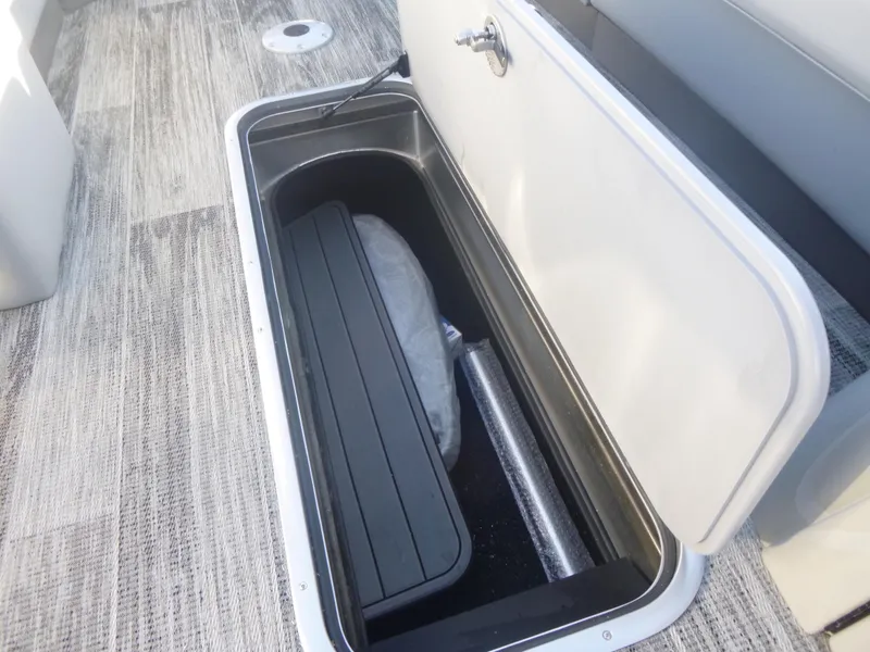 Slide: The Image of 2024 Ranger Reata 223C storage compartment with open hatch, showcasing interior space. - 25
