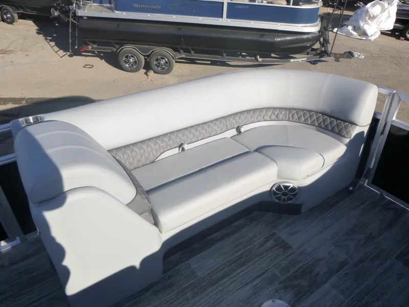 Slide: The Image of 2024 Ranger Reata 223C boat interior with gray cushioned seating and speaker. - 26