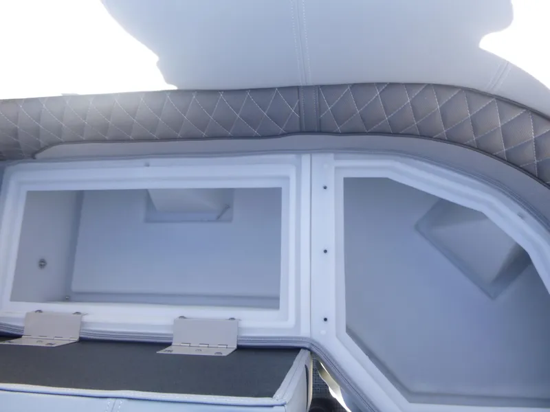 Slide: The Image of 2024 Ranger Reata 223C interior storage compartment with quilted upholstery detail. - 27