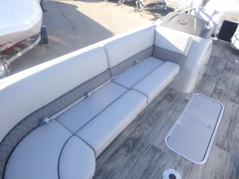 Slide: The Image of 2024 Ranger Reata 223C boat interior with gray seating and wood-style flooring. - 28