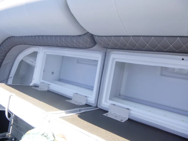 Slide: The Image of 2024 Ranger Reata 223C boat storage compartments with cushioned seating. - 29