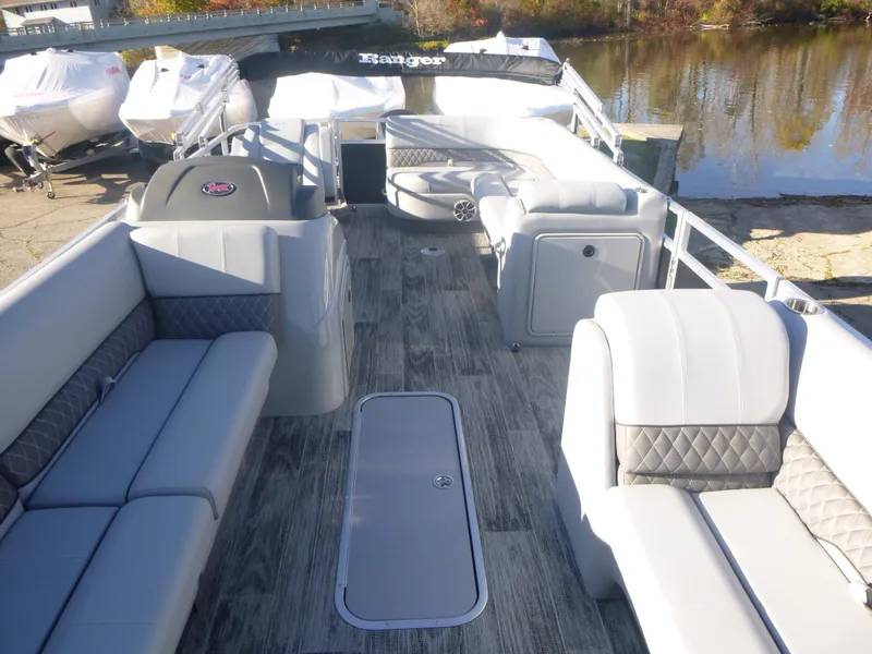 Slide: The Image of 2024 Ranger Reata 223C pontoon boat with spacious seating and modern design. - 30