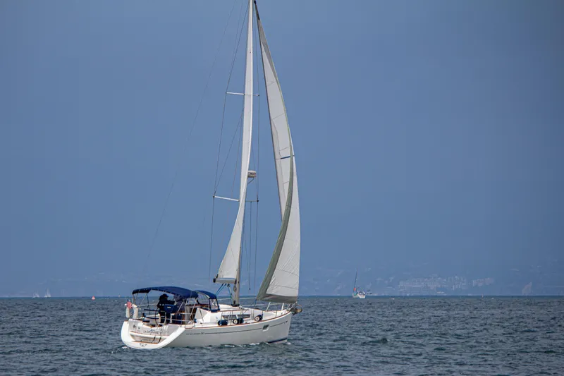 Slide: The Image of 2007 Jeanneau Sun Odyssey 36i sailboat on open water under clear skies. - 1