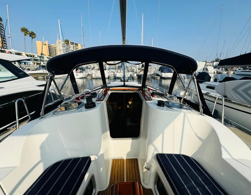 Slide: The Image of 2007 Jeanneau Sun Odyssey 36i sailboat cockpit in marina, featuring sleek design and comfortable seating. - 12