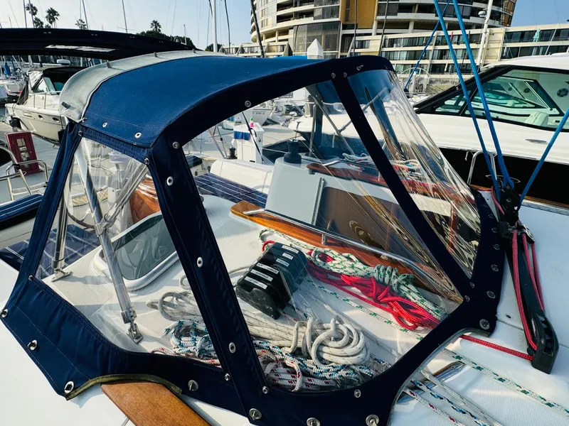Slide: The Image of 2007 Jeanneau Sun Odyssey 36i sailboat cockpit with blue canopy and marina background. - 14
