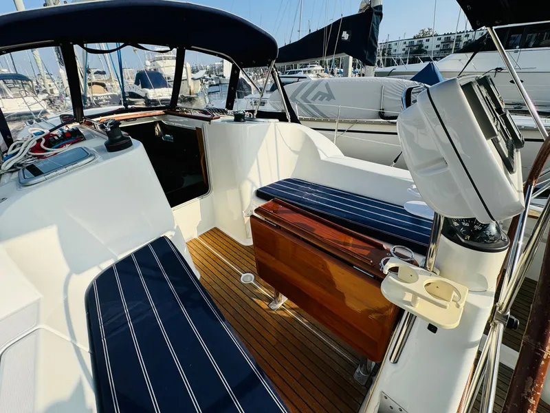 Slide: The Image of 2007 Jeanneau Sun Odyssey 36i sailboat cockpit with striped seating and wooden flooring. - 20