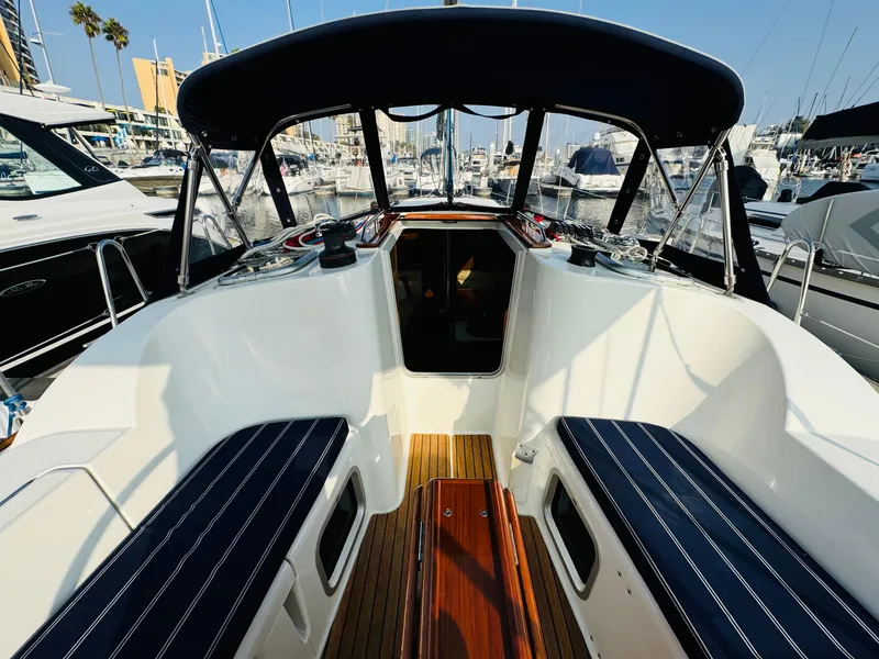 Slide: The Image of 2007 Jeanneau Sun Odyssey 36i sailboat cockpit with seating and canopy in marina. - 21