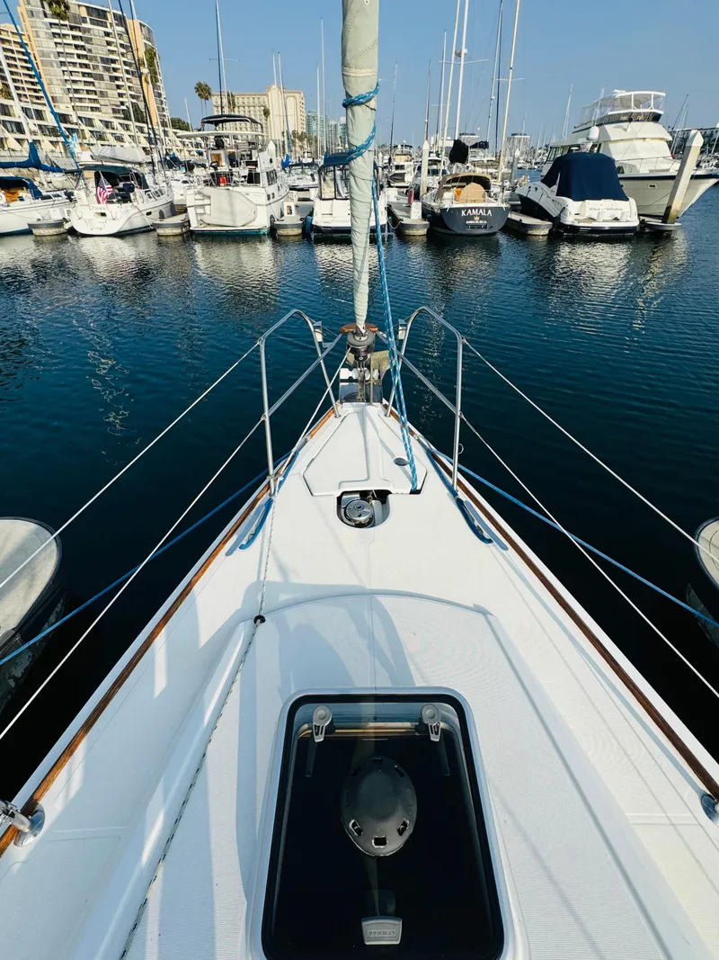 Slide: The Image of Jeanneau Sun Odyssey 36i sailboat docked in marina, 2007 model, surrounded by other boats. - 22