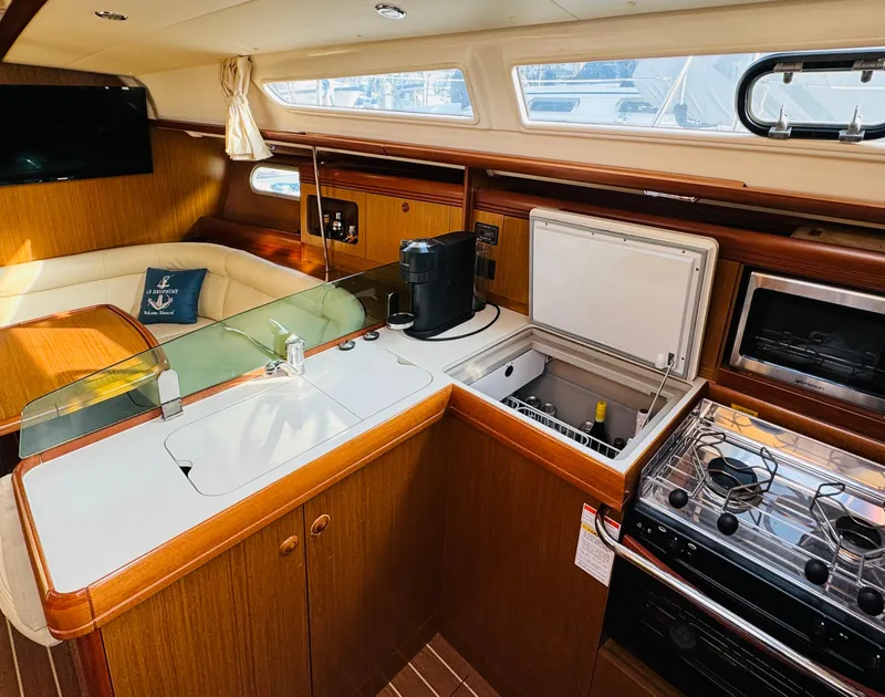 Slide: The Image of Interior of 2007 Jeanneau Sun Odyssey 36i yacht with kitchen and seating area. - 26
