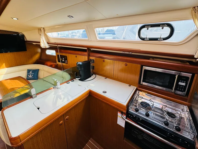 Slide: The Image of Interior of 2007 Jeanneau Sun Odyssey 36i yacht with modern kitchen and seating area. - 27