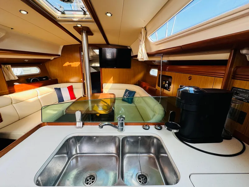 Slide: The Image of Interior of 2007 Jeanneau Sun Odyssey 36i yacht with modern kitchen and cozy seating area. - 29