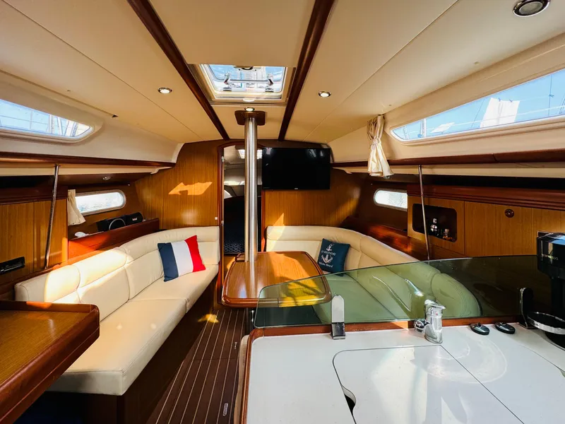Slide: The Image of Interior of 2007 Jeanneau Sun Odyssey 36i sailboat, featuring elegant wood finish and cozy seating. - 33