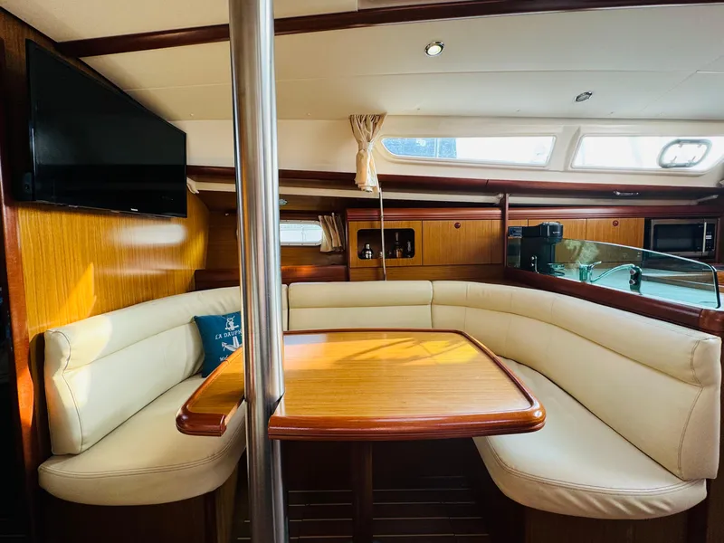 Slide: The Image of Interior of 2007 Jeanneau Sun Odyssey 36i yacht with cozy seating and wooden table. - 36