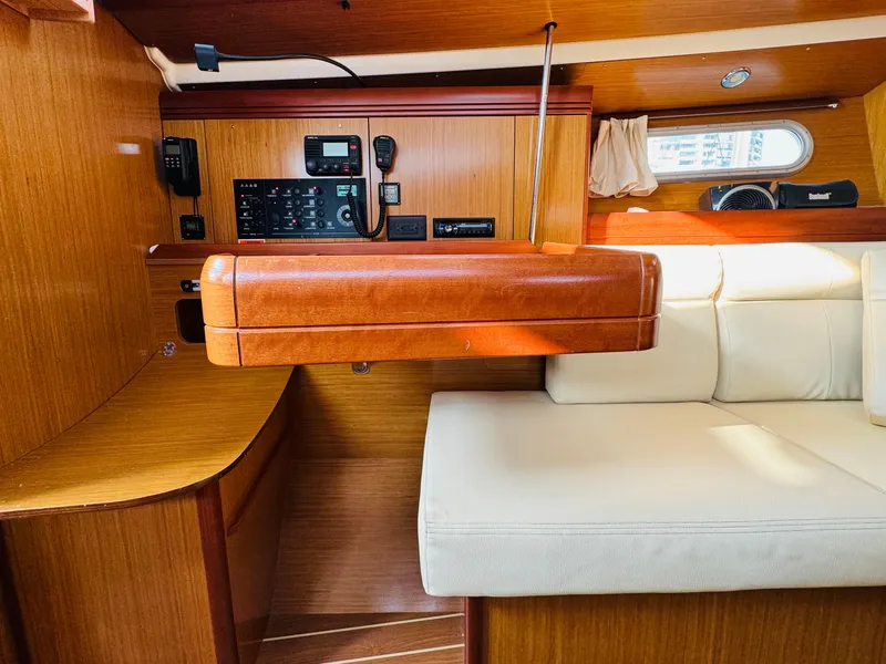 Slide: The Image of Interior of 2007 Jeanneau Sun Odyssey 36i sailboat with wood paneling and beige seating. - 38