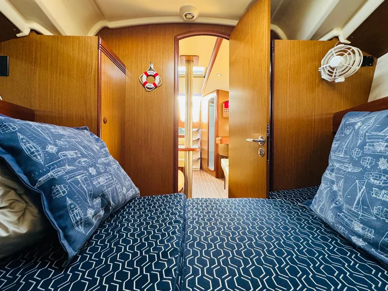 Slide: The Image of Interior cabin of 2007 Jeanneau Sun Odyssey 36i sailboat, featuring nautical-themed bedding. - 42