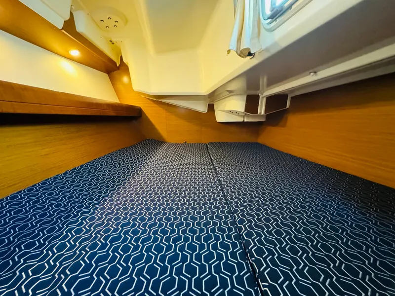 Slide: The Image of Cozy cabin interior of 2007 Jeanneau Sun Odyssey 36i sailboat with patterned bedding. - 44