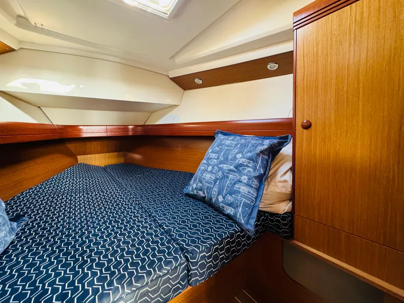 Slide: The Image of Cozy cabin interior of 2007 Jeanneau Sun Odyssey 36i sailboat with patterned bedding. - 45