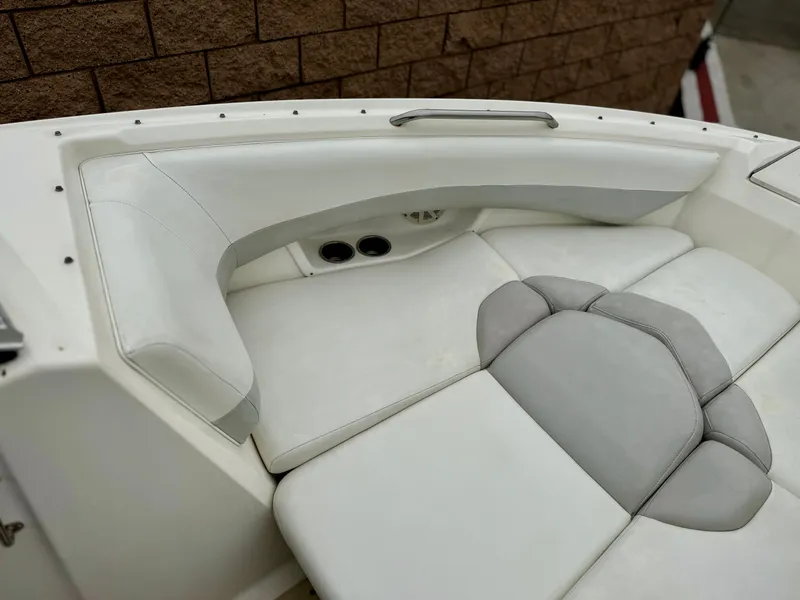 Slide: The Image of 2006 Larson LXi 248 boat interior with white and gray seating. - 13