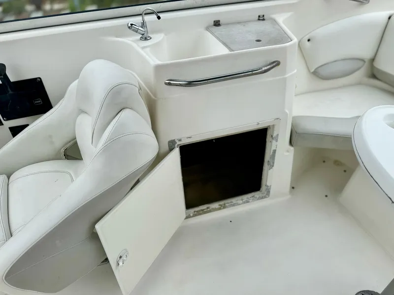 Slide: The Image of Open storage compartment on 2006 Larson LXi 248 boat interior. - 20