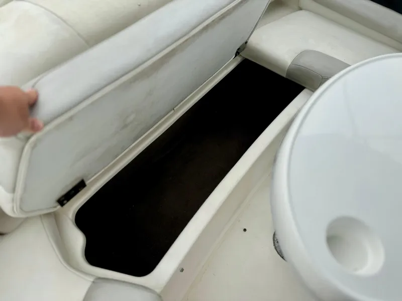 Slide: The Image of 2006 Larson LXi 248 boat cockpit with steering wheel and white captain's chair. - 21