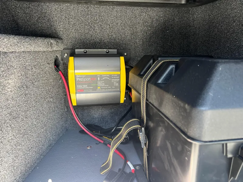 Slide: The Image of 2024 Princecraft Holiday 162 DLX WS MAX boat battery compartment with ProSport charger. - 12