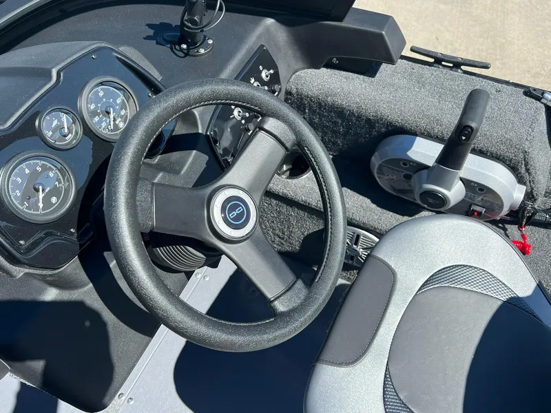 Slide: The Image of 2024 Princecraft Holiday 162 DLX WS MAX boat dashboard with steering wheel and controls. - 14