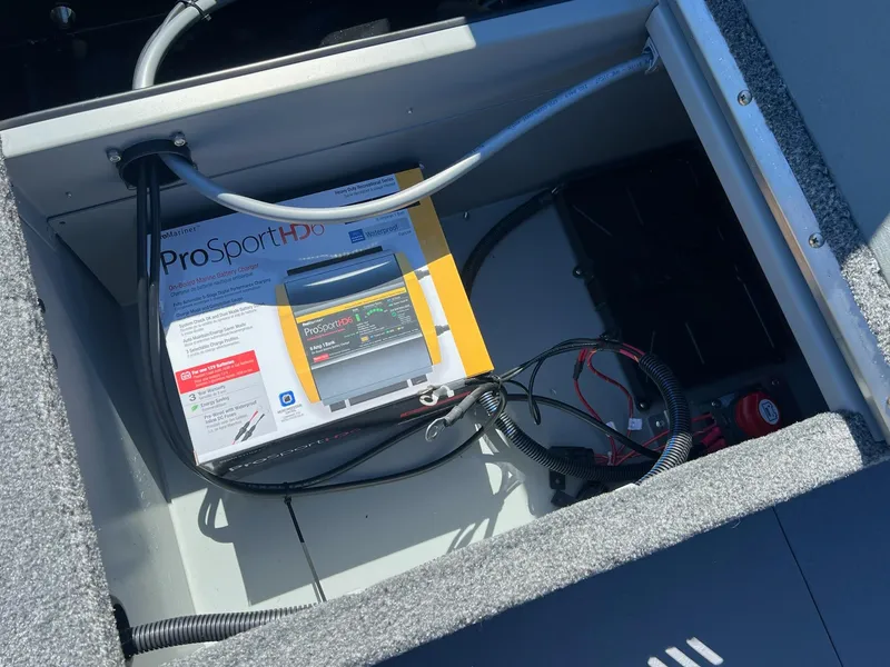 Slide: The Image of 2024 Princecraft Holiday 162 DLX WS MAX boat storage compartment with ProSportHD battery charger. - 16