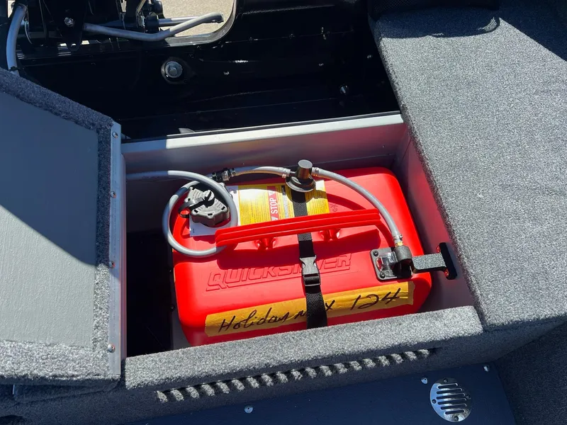Slide: The Image of 2024 Princecraft Holiday 162 DLX WS MAX boat storage compartment with red fuel tank. - 17