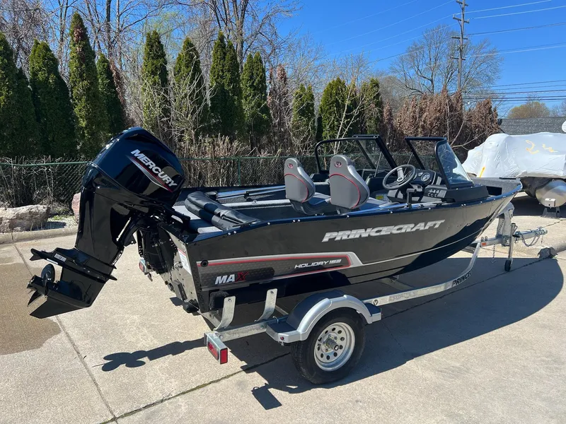Slide: The Image of 2024 Princecraft Holiday 162 DLX WS MAX boat on trailer, parked outdoors. - 3