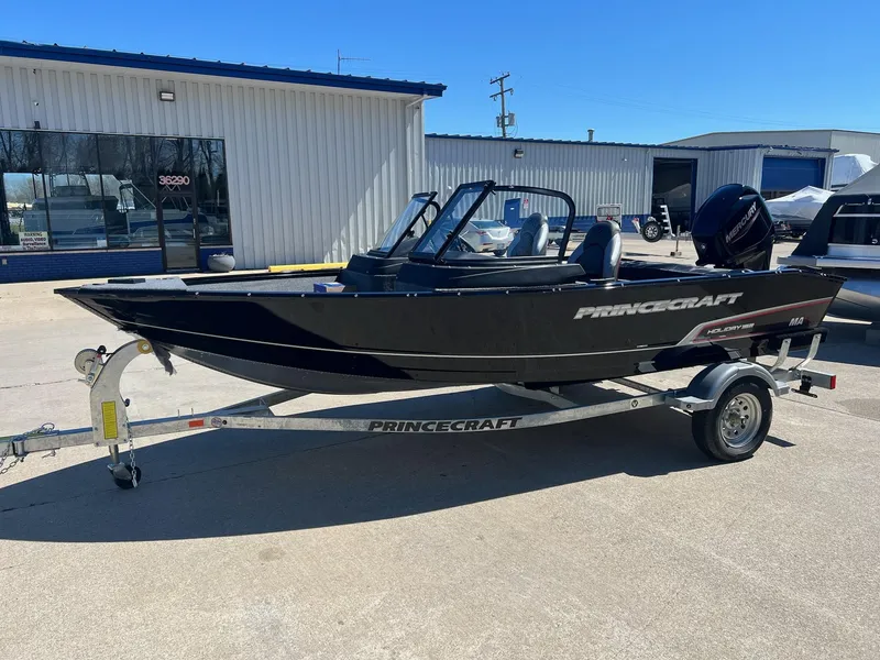 Slide: The Image of 2024 Princecraft Holiday 162 DLX WS MAX boat on trailer, parked outside a building. - 5