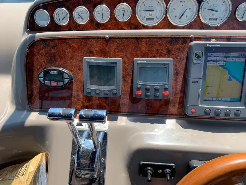 Slide: The Image of Dashboard of a 2004 Larson Cabrio 370 boat with navigation and control instruments. - 3
