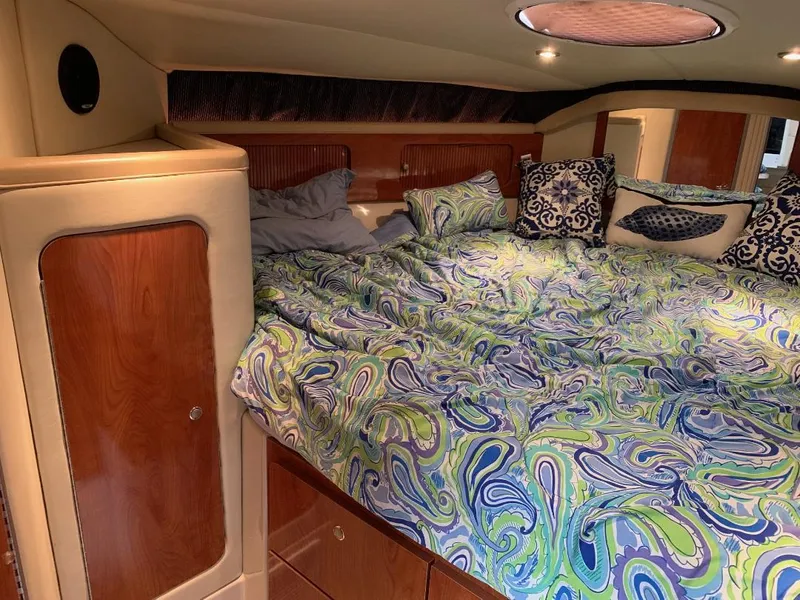 Slide: The Image of Luxurious cabin interior of 2004 Larson Cabrio 370 with vibrant bedding and wood accents. - 8