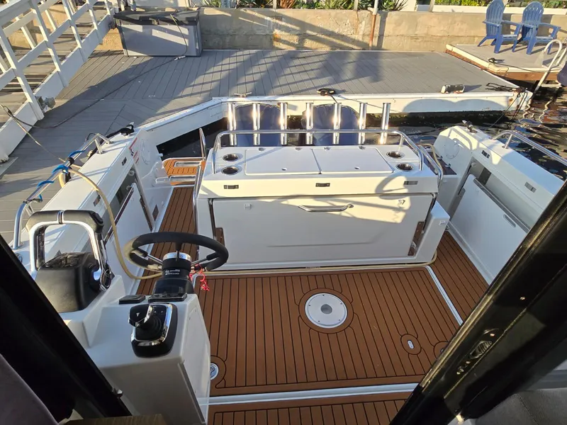 Slide: The Image of 2020 Jeanneau NC 895 Sport boat interior with teak flooring and modern helm. - 11