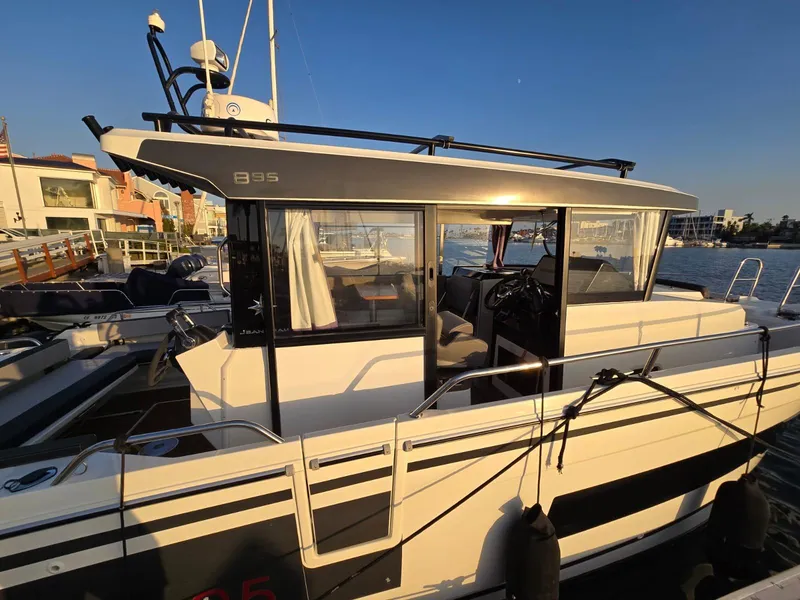 Slide: The Image of 2020 Jeanneau NC 895 Sport boat docked at marina, side view in sunlight. - 17