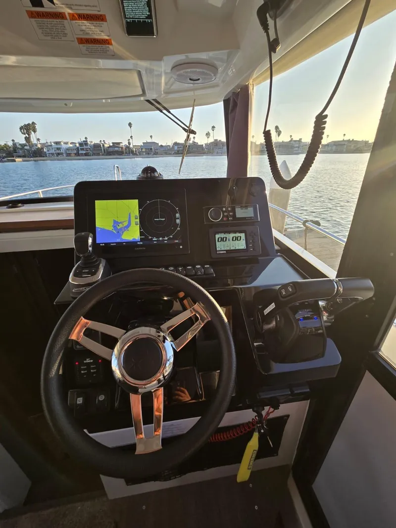 Slide: The Image of 2020 Jeanneau NC 895 Sport helm with navigation display and steering wheel. - 25