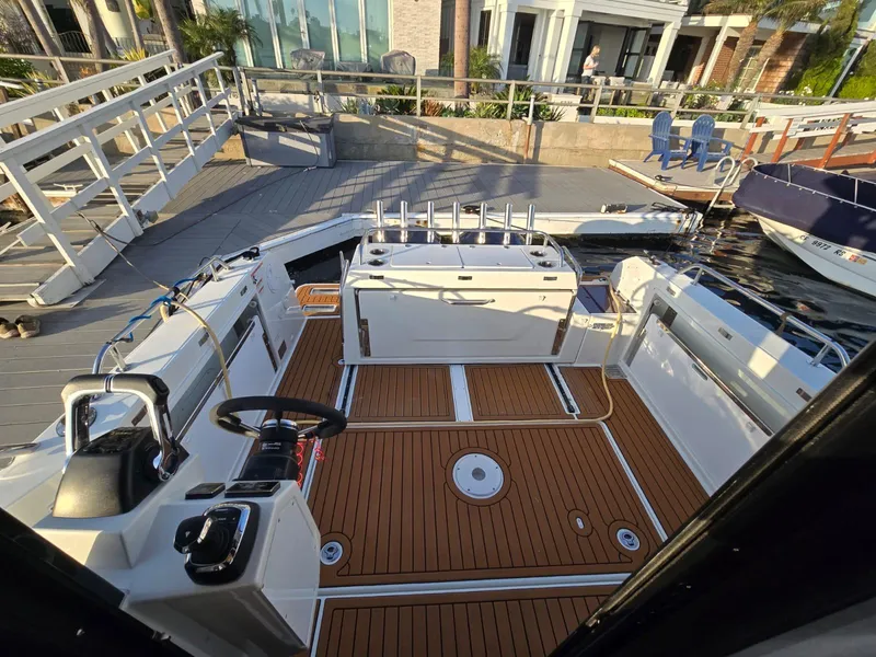 Slide: The Image of 2020 Jeanneau NC 895 Sport boat interior with teak flooring and modern helm. - 38