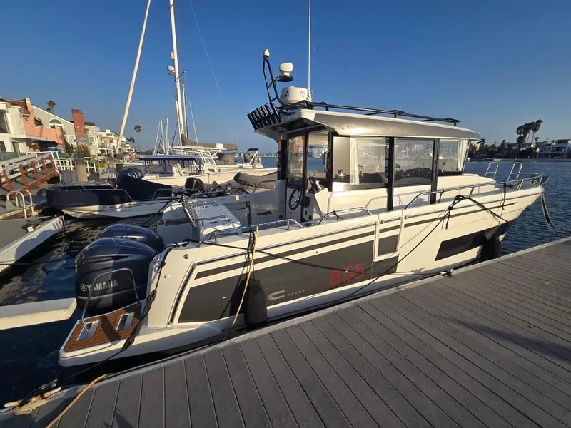 Slide: The Image of 2020 Jeanneau NC 895 Sport boat docked at marina with clear blue sky. - 4