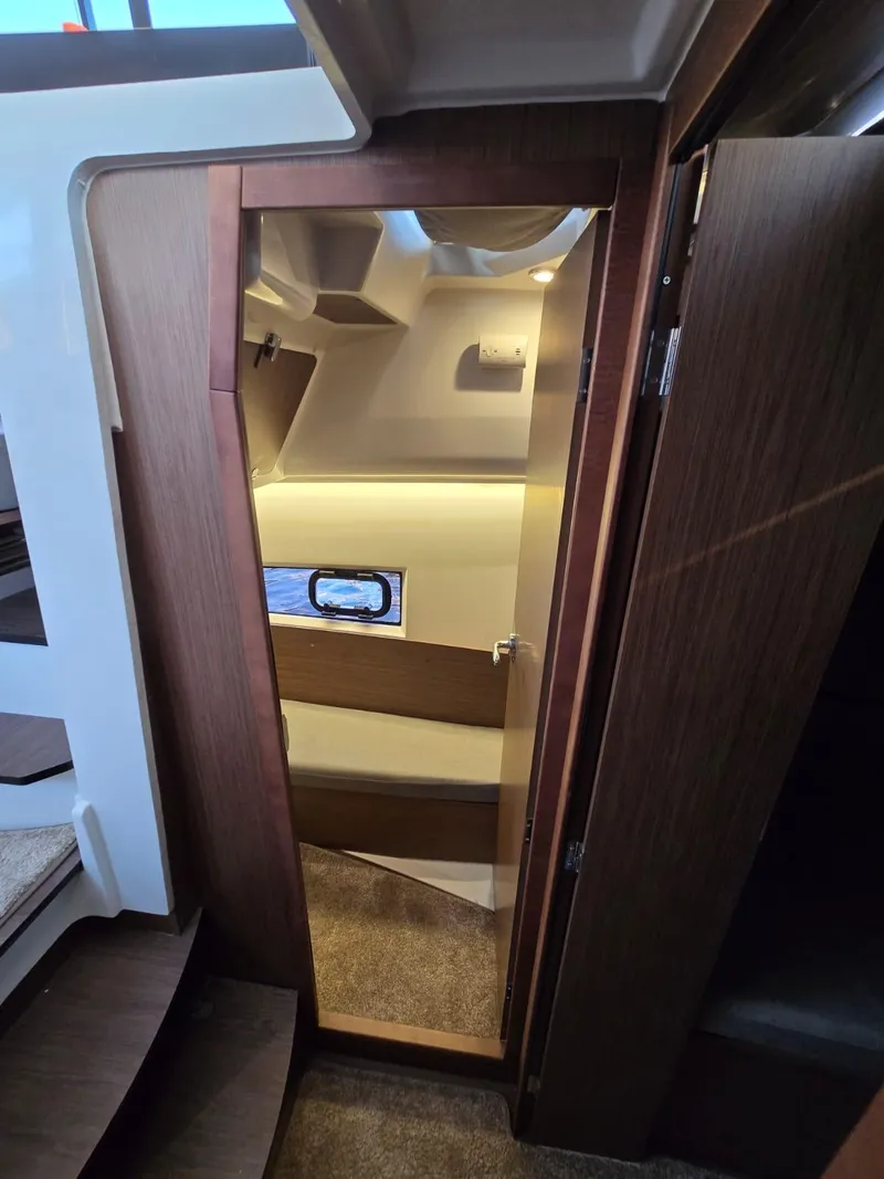Slide: The Image of 2020 Jeanneau NC 895 Sport cabin interior with wooden finishes and window. - 41