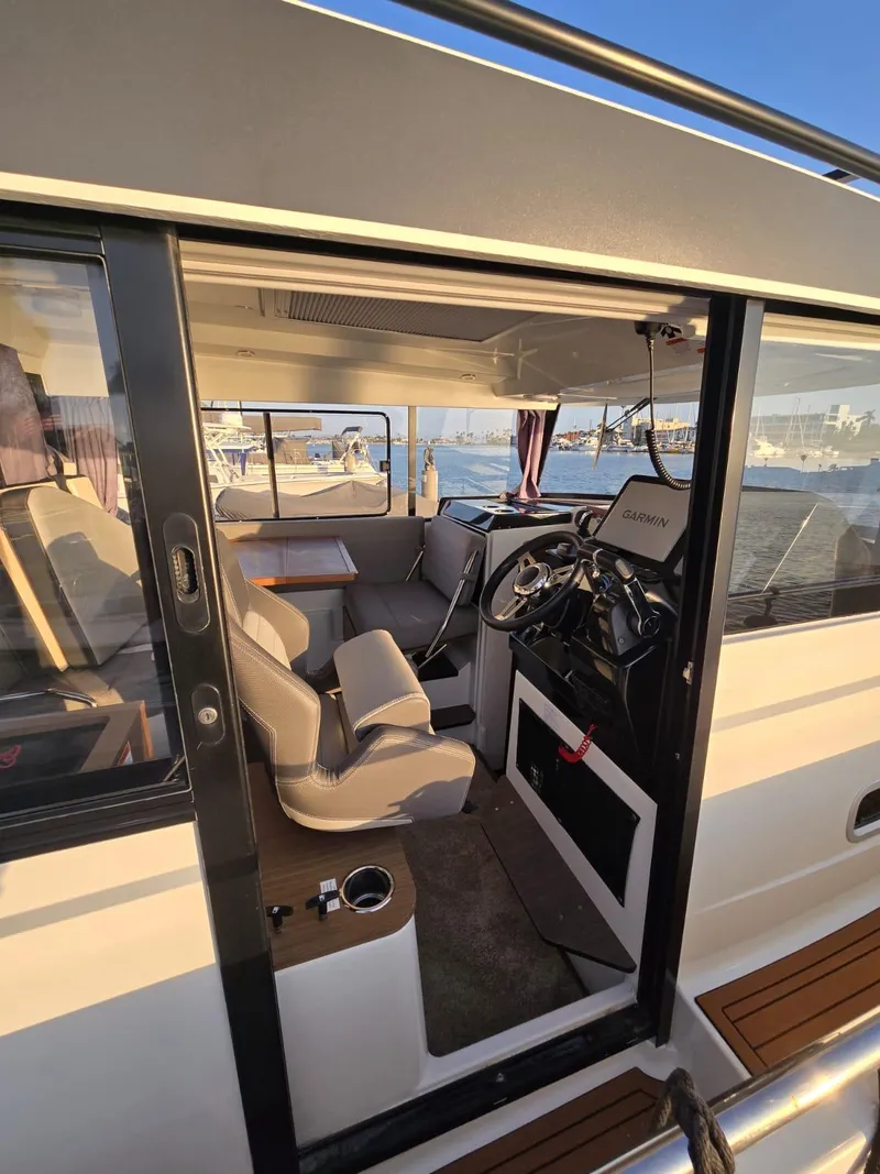 Slide: The Image of 2020 Jeanneau NC 895 Sport boat interior with helm and seating area. - 42
