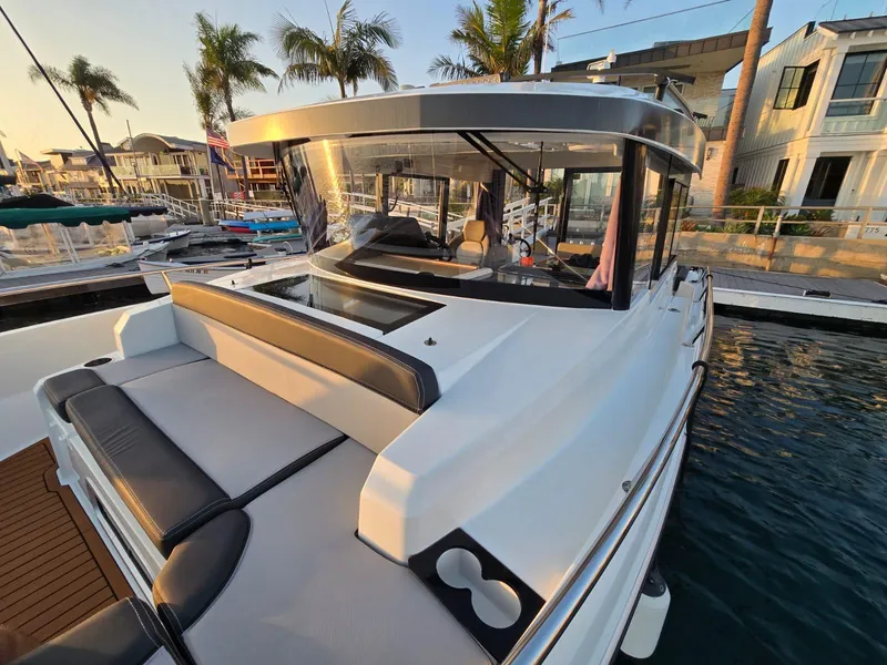 Slide: The Image of 2020 Jeanneau NC 895 Sport boat docked at marina with palm trees. - 46