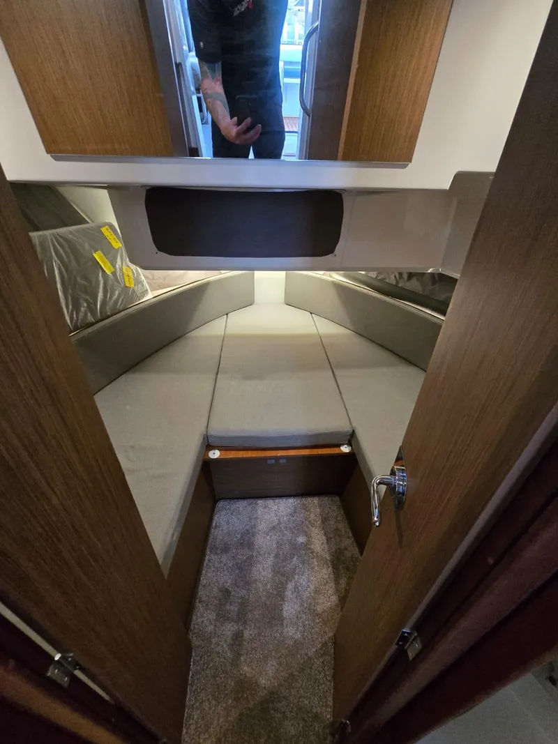 Slide: The Image of 2020 Jeanneau NC 895 Sport cabin interior with cozy sleeping area and wooden finishes. - 47