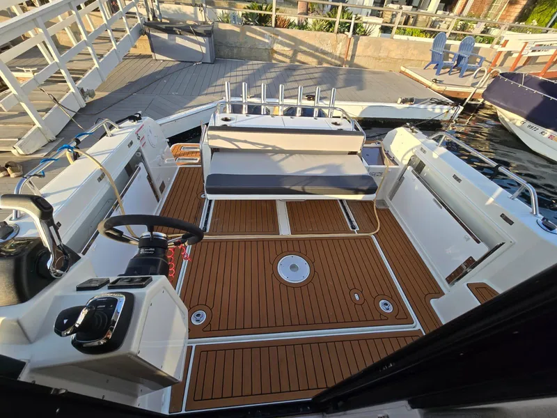 Slide: The Image of 2020 Jeanneau NC 895 Sport boat interior with teak flooring and seating area. - 49