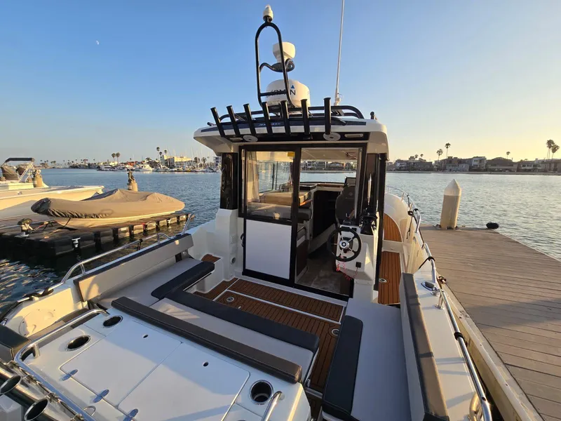 Slide: The Image of 2020 Jeanneau NC 895 Sport boat docked at marina during sunset. - 9