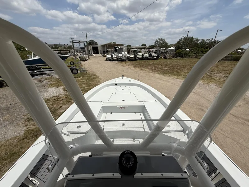 Slide: The Image of 2024 Pathfinder 2600 HPS boat viewed from helm, parked outdoors under cloudy sky. - 10