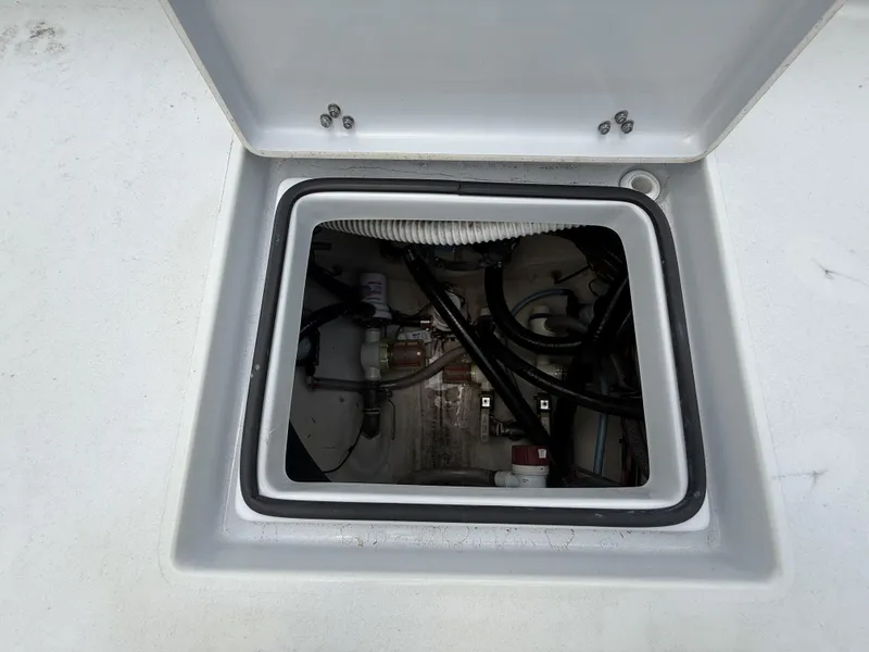 Slide: The Image of Open hatch of 2024 Pathfinder 2600 HPS boat showing internal wiring and components. - 15