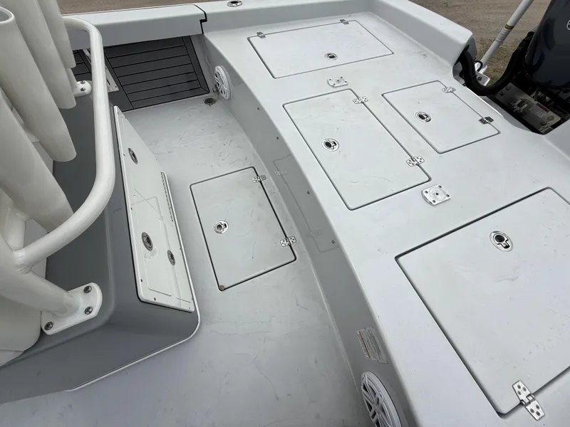 Slide: The Image of 2024 Pathfinder 2600 HPS boat deck with storage compartments and rod holders. - 16