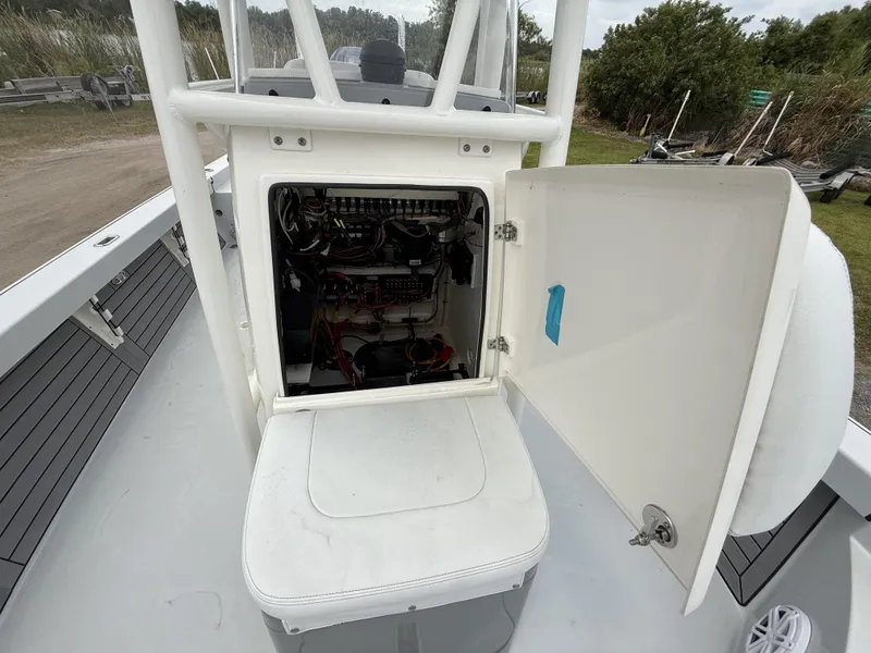 Slide: The Image of Open electrical compartment on 2024 Pathfinder 2600 HPS boat, showing wiring and components. - 20